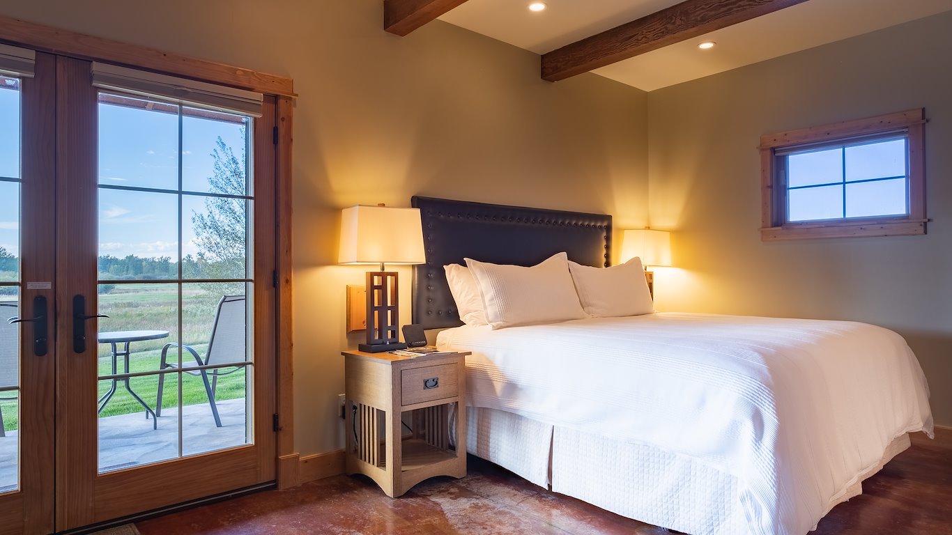 Cozy bedroom with patio doors and countryside view.