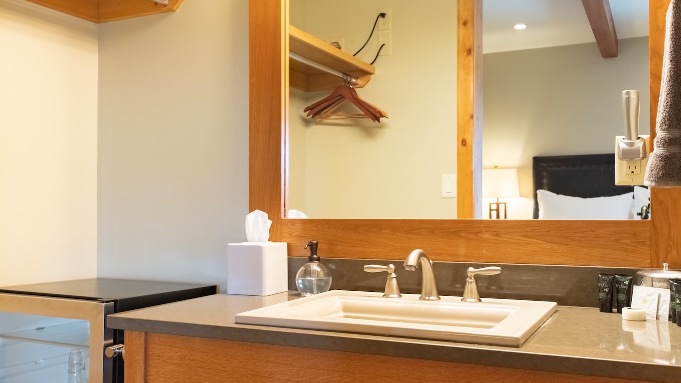 Modern bathroom with sink, mirror, and amenities