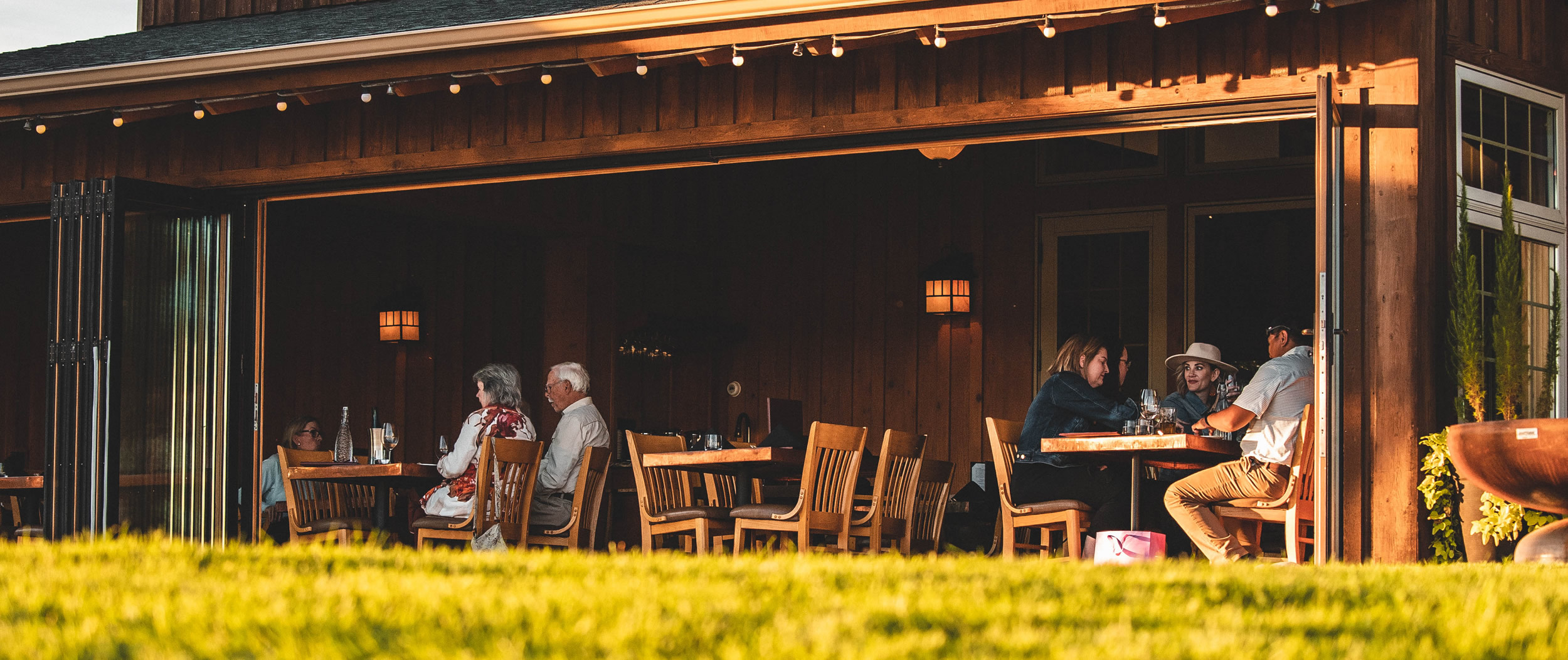 grl hero img falldining Outdoor dining in wooden restaurant setting