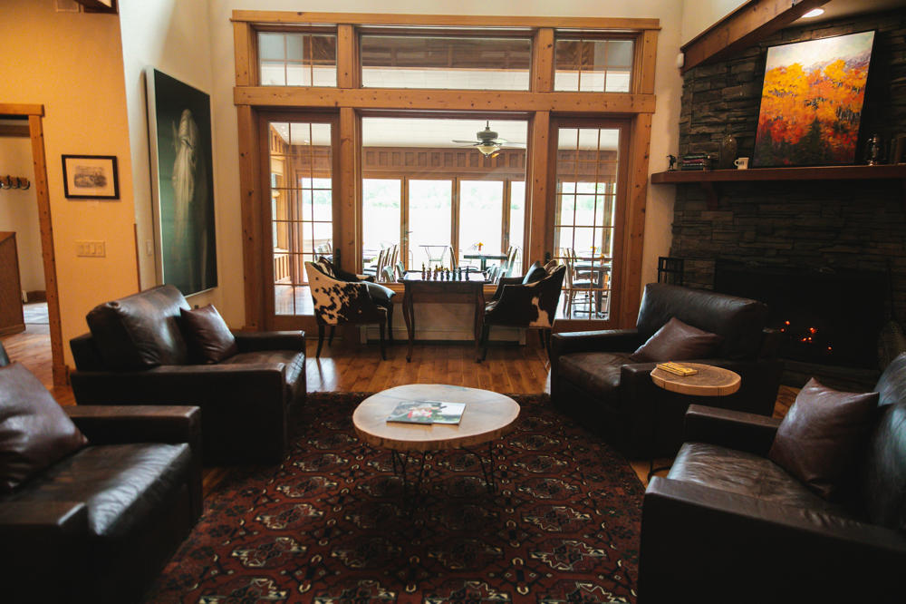 Cozy living room with fireplace and leather chairs.
