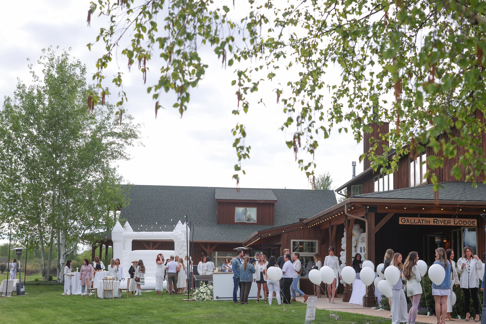 Outdoor wedding reception at rustic lodge.