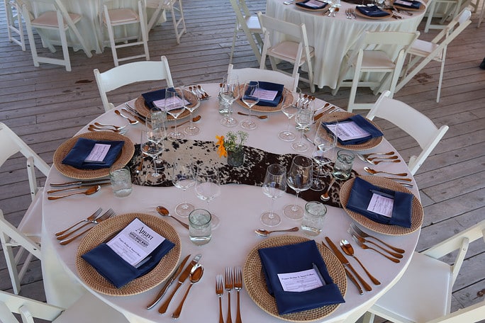 Elegant table setting with blue napkins and menus.