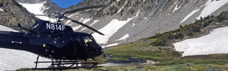 Helicopter landed in snowy mountainous landscape